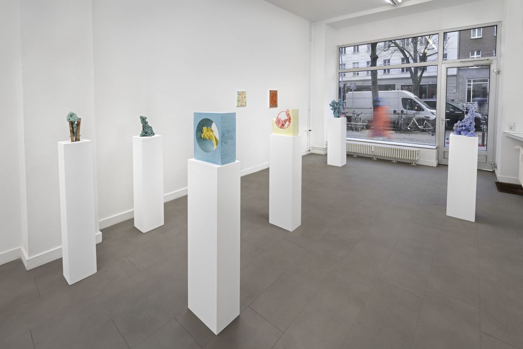 Exhibition view, colourful sculptures by Lucy Teasdale on plinths